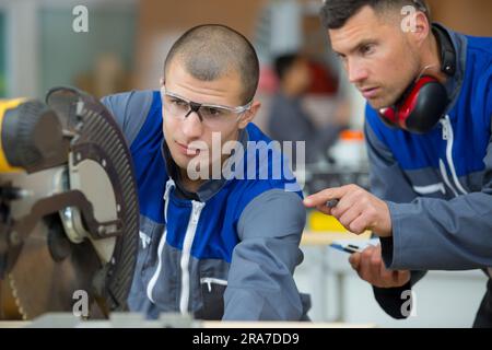 construction worker industrial carpenter using circular saw Stock Photo