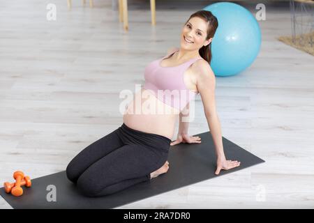 pregnant woman exercising in anticipation of child birth Stock Photo