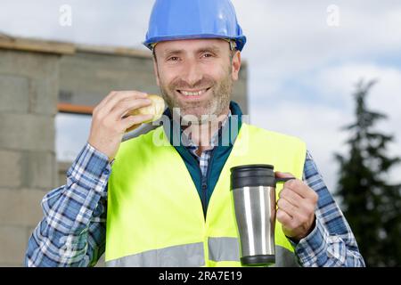 male engineer drinking hot coffee in his lunch break Stock Photo