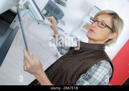 female printing technician input on the codes Stock Photo