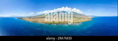 An aerial view of the West Maui Mountains looking into Launiupoko and the valley behind, Maui, Hawaii, USA. The island of Molokai is on the horizon pa Stock Photo