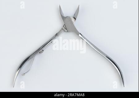 Nail foot open scissors close up view isolated on studio background Stock Photo