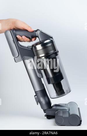 Cleaning floor with vacuum cleaner sweep brush side view isolated on studio background Stock Photo