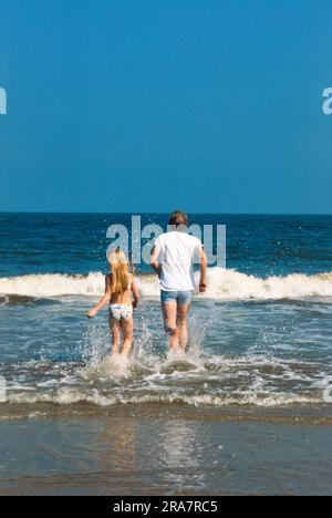 President Jimmy Carter and daughter, Amy Carter, run in the surf at Sea Island, Georgia while on vacation. Photo by Bernard Gotfryd Stock Photo