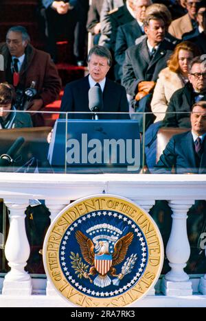 Jimmy Carter is sworn in as 39th President of the United States by Supreme Court Chief Justice Warren Burger. By Carter's side is his wife, Rosalynn and Vice President Walter Mondale. Photograph by Bernard Gotfryd Stock Photo