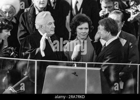 Jimmy Carter is sworn in as 39th President of the United States by Supreme Court Chief Justice Warren Burger. By Carter's side is his wife, Rosalynn and Vice President Walter Mondale. Photograph by Bernard Gotfryd Stock Photo