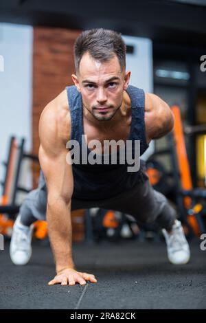 young fit caucasian male doing static exercise Stock Photo