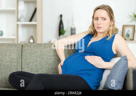 pregnant woman feeling pain and discomfort Stock Photo