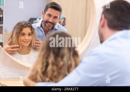 male hairdresser discussing cut with female client Stock Photo