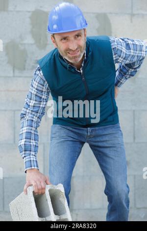 construction worker feeling backpain in lumbar area Stock Photo