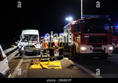 02 July 2023, Bavaria, Bischbrunn: Firefighters are on duty at the scene of an accident on the A3 autobahn. Two people were injured in a rear-end collision on the A3 in the Main-Spessart district. The two men were driving a van from the north in the direction of Würzburg in the early hours of Sunday morning when they hit an articulated truck, presumably out of carelessness. Their car came to a standstill on the hard shoulder between the Spessart rest area and Marktheidenfeld. The 22-year-old passenger was trapped in the vehicle and had to be freed by the fire department. He was taken to a hosp Stock Photo