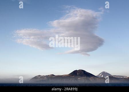 Lenticular cloud over Atlasova, Kuril Islands, Sea of Okhotsk, Far East Russia Stock Photo