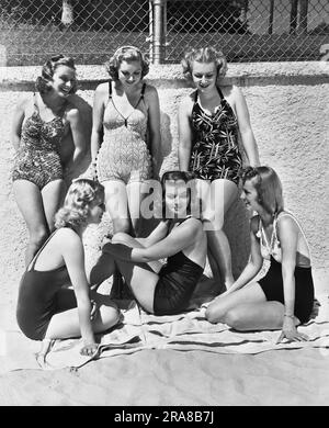 Malibu, California:  1938 These six lucky actresses have been told they must get suntans for their upcoming roles in "Give Me a Sailor", so here they are doing their job on Malibu Beach. Standing L-R: Cheryl Walker, Ruth Rogers, and Harriett Haddon, seated L-R: Marion Weldon, Laurie Lane, and Dorothy White. Stock Photo