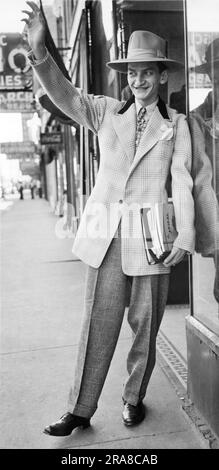 Chicago, Illinois:  September 24, 1943 A man wearing the very latest in zoot-suit styles and a hat to match. The new style reflects War Production Board rules on the conservation of fabrics. Stock Photo