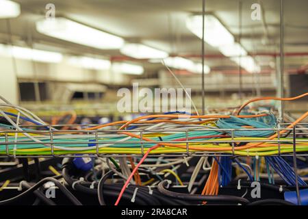 The web of cables in the server room can be confusing to navigate. The web of cables in the server room can be confusing to navigate. Stock Photo