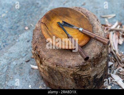 Making handmade wooden bowl with wood carving tools. Stock Photo