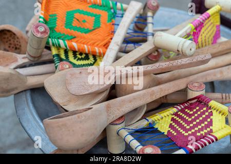Wooden spoons and small toy beds closeup. selective focus. Stock Photo