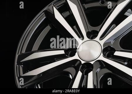 Beautiful modern cast disc on a black background close-up. Stock Photo