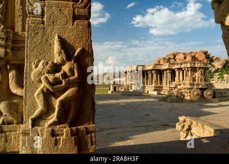 Lovers on a pillar in the elegant and ornate Kalyana Mandapa Wedding Pavilion and stone chariot in Vitthala Temple complex in Hampi, Karnataka, South Stock Photo