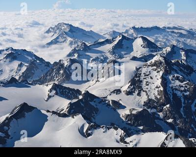 AERIAL VIEW. Mountain range of the Upper Maurienne Valley viewed from the north in the morning light. Savoie, Auvergne-Rhône-Alpes, France. Stock Photo