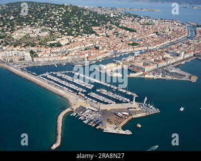 AERIAL VIEW. The city of Sète, its marina on the Mediterranean shores and the Étang (a pond) de Thau in the distance. Hérault, Occitanie, France. Stock Photo