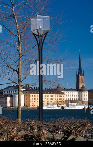 Street lamp, view of Riddarholmen church, in Riddarfjarden, Riddarholmen island, Stockholm, Sweden, Riddarholmskyrkan, Riddarfjaerden, lantern Stock Photo
