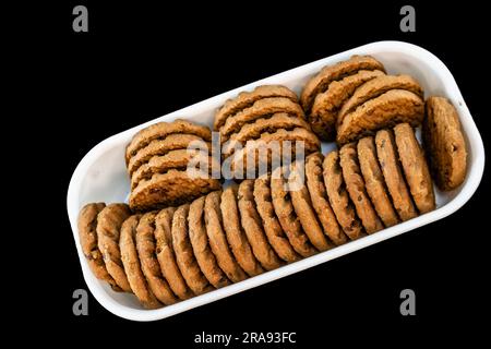 A Stack Of Delicious Chocolate Chip Cookies In Square Bowl on a Black Surface. Top View Stock Photo