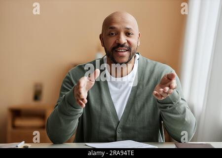 Minimal front view portrait of black man talking animatedly at camera, copy space Stock Photo