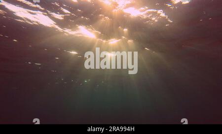 June 17, 2023, Red Sea, Egypt: Evening sunlight creates beautiful veil, consisting of sunlight at sunset. Underwater ocean waves oscillate and flow with rays of light at sundown, Red sea, Egypt (Credit Image: © Andrey Nekrasov/ZUMA Press Wire) EDITORIAL USAGE ONLY! Not for Commercial USAGE! Stock Photo