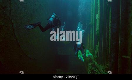 Scuba diver swim inside of ferry Salem Express shipwreck, Red sea, Safaga, Egypt Stock Photo