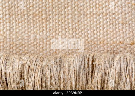 Close-up shot of worn seat fabric - appears to be mixed fibre not 100% cotton. For frayed edges, seen better days, out of condition metaphor. Stock Photo