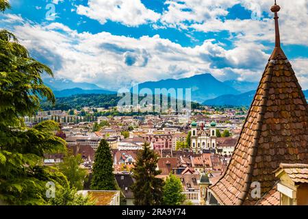 Picturesque view of Lucerne's Old Town with the Jesuit Church in front and an impressive mountainous panorama in the back, seen from the famous... Stock Photo