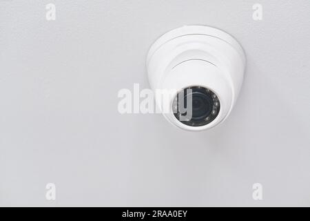 Cctv on white ceiling in modern building Stock Photo