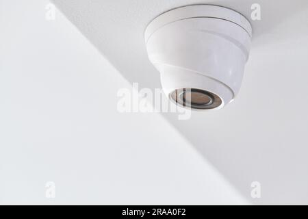 Cctv on white ceiling in modern building Stock Photo