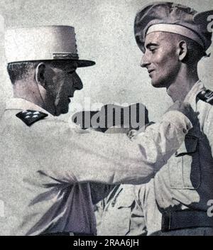 General JEAN de LATTRE DE TASSIGNY French military commander, here seen pinning a medal on his son Bernard in 1951.     Date: 1889 - 1952 Stock Photo