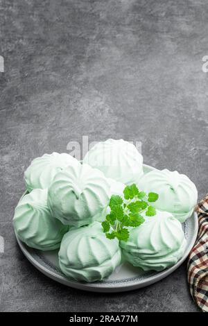 Mint  marshmallows on ceramic plate on gray background Stock Photo