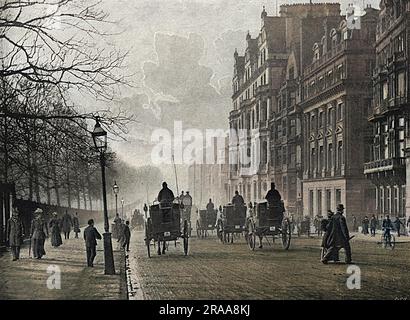 Cabs travelling westwards on Piccadilly, with Green Park on the left and Hyde Park Corner ahead.     Date: 1895 Stock Photo