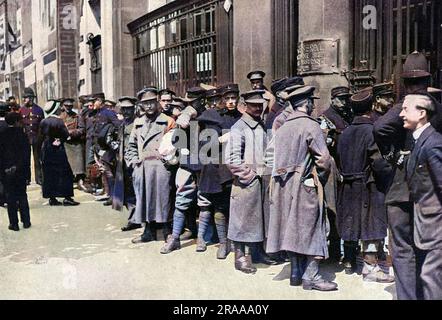 Belgian Army troops, on leave in London, wait at Aldwych for railway passes to visit their refugee families.  As many men who were granted leave from the front had relatives in England, Belgian soldiers were a familiar sight in London during the First World War.     Date: 1915 Stock Photo