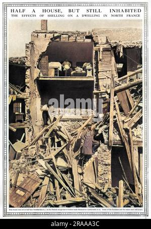 The effects of shelling on a dwelling in North France with the house cut in half by bombardment but with stairs and some furniture still left intact, enabling it to be occupied by French troops.     Date: 1915 Stock Photo