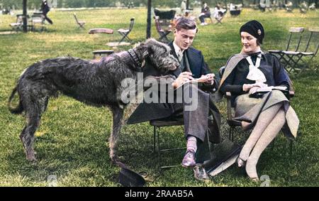 Mr and Mrs Bryan Guinness (1910 - 2003), formerly Miss Diana Freeman Mitford, later Lady Mosley, pictured enjoying a 'quiet half-hour' in Hyde Park in 1930 with their immense Irish wolfhound.     Date: 1930 Stock Photo