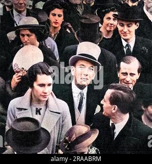 Noel Coward (Sir Noel Peirce Coward, 1899-1973), English actor, singer, playwright, director and composer, sporting a grey top hat, and pictured outside Buckingham Palace where he was among the crowd watching the Coronation procession of King George VI on 12 May 1937.     Date: 1937 Stock Photo
