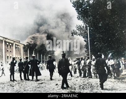 Buildings on fire in the city of Brest-Litovsk. The city was captured by German forces in December 1915, and in March 1918 was the scene of the signing of a treaty which ended the war between Russia and Germany. The city now lies in Belarus, very near the border with Poland.     Date: 1914 - 1918 Stock Photo