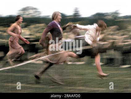 Racing women reach the finishing line in this high-speed action shot ...
