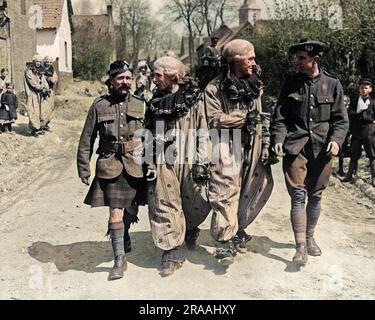Two entertainers in costume, walking along a road with Scots soldiers near the Western Front during World War One.  They belonged to an entertainment troupe called the Balmorals, seen here on their way to a performance.     Date: circa 1916 Stock Photo