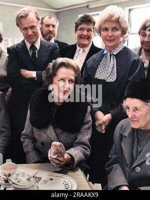 Margaret Thatcher, Prime Minister, enjoying a Cornish pasty and a cup of tea during her visit to Marazion Community Centre, Cornwall.  Also present are David Harris MP and the Lady Dowager St Levan.     Date: Apr-84 Stock Photo