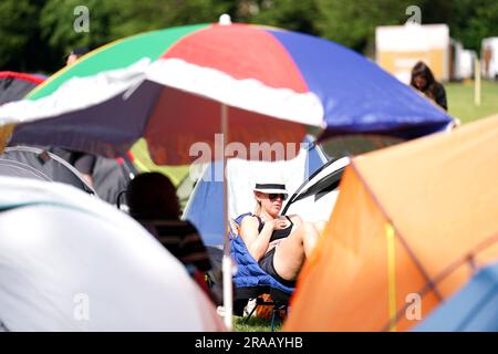 A spectator rests while in the overnight queues ahead of the championships which start on Monday. Picture date: Sunday July 2, 2023. Stock Photo