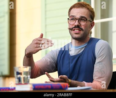 Potsdam, Germany. 02nd July, 2023. Kim de l'Horizon reads from his work 'Blood Book' in the garden of Villa Quandt at the Potsdam literature festival LIT:Potsdam. Credit: Jens Kalaene/dpa/Alamy Live News Stock Photo