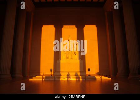 The rising sun shines inside the Lincoln Memorial in Washington, DC, around the March and September equinoxes. Stock Photo