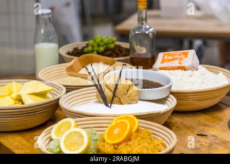 Production of an original Dresden Christstollen in Dresden, Germany. Ingredients for Dresden Christmas Stollen are butter, sugar, almonds, flour, spices, milk, yeast, candied orange peel and lemon peel, rum and powdered sugar. Stock Photo