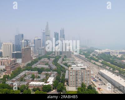 Chicago, Illinois, USA. 28th June, 2023. View of downtown Chicago from south showing thick wildfire smoke blowing on northerly winds from Canada. Stock Photo